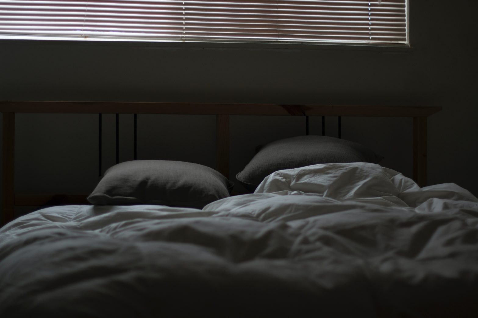 An empty bed with two pillows to illustrate lack of sleep in menopause